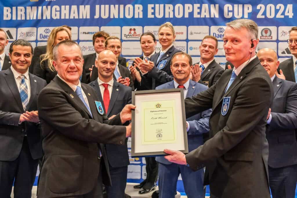 Keith Merrick being presented with a letter of thanks by EJU Commission members at this year's Junior European Cup